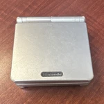 Nintendo Game Boy Advance Sp AGS-001 Silver Handheld System Backlight. Fixed Price $80.00.