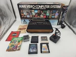 Atari Video Computer System CX-2600 Includes Box, Manual, Games, Read. Fixed Price $150.00.