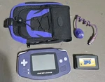 Nintendo Game Boy Advance AGB-001 Indigo Console With Mario 3, Nyko Light & Case. Fixed Price $129.00.